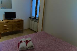 a bedroom with two pairs of shoes on a bed at Casale Ceppone in Vico Equense