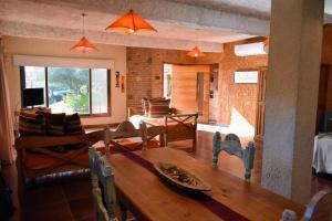 a living room with a wooden table and a dining room at Moradillo Apart in La Cuesta