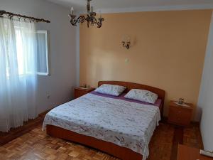a bedroom with a bed and a chandelier at Franceska in Korčula