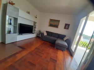 a living room with a couch and a flat screen tv at Franceska in Korčula +1 photo