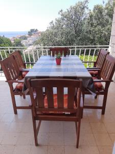 a table with two chairs and a potted plant on it at Franceska in Korčula
