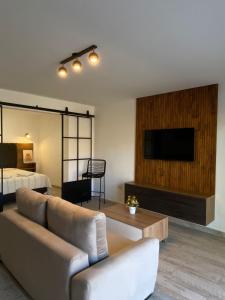 a living room with a couch and a flat screen tv at Rockaway Apart in Miramar