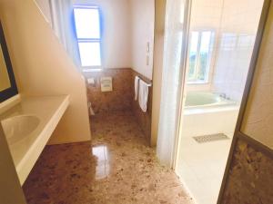 a bathroom with a tub and a sink at Umi no Gohanya Noramare - Vacation STAY 18191v in Masuda