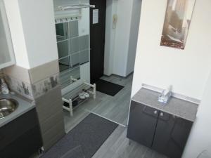 a small bathroom with a sink and a mirror at Universitate Residence in Bucharest