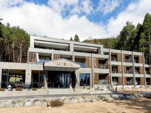 a large concrete building with trees in the background at Kumonoue Fuji Hotel - Vacation STAY 37547v in Oishi