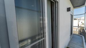 a window with a view of a balcony at be Unforgettable Apartment in Faro