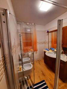 a bathroom with two sinks and a glass shower at New Bedrooms Mamma Gigetta in Noventa di Piave