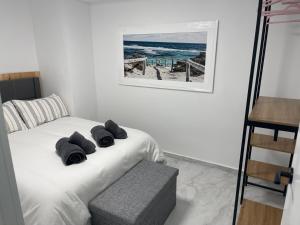 a bedroom with a bed with towels on it at Las Terrazas del Castillo in Almansa