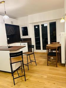 eine Küche und ein Esszimmer mit Tisch und Stühlen in der Unterkunft Belle Vue in Meudon