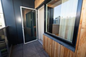 a balcony with two windows in a building at LL Properties - Luxury Penthouse in Akureyri