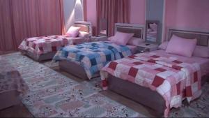 a rendering of a bedroom with two beds at فندق لؤلؤة الريف in Kafr ʼakīm