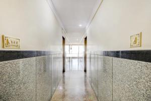 a hallway of a building with a glass wall at OYO Hotel Vijay Residency in Bangalore