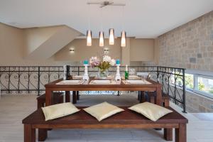 a dining room with a wooden table with pillows at Jasmin in Posedarje