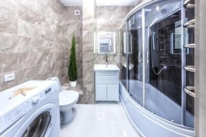 a laundry room with a washer and dryer in a bathroom at Европейская Пассаж ЦУМ in Dnipro