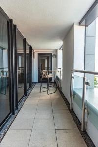 a hallway of a building with a table and chairs at Luxurious 2 Bed - RIVER VIEW in Liverpool