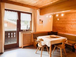 a dining room with a table and chairs and a window at Haus Bitschnau in Klösterle