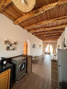 a kitchen with a washer and dryer in a room at Le petit Chalet. in Essaouira +41 photos