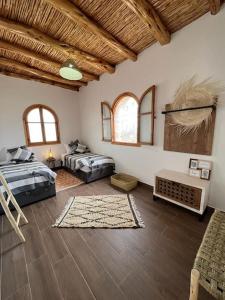 a large room with two beds and a table at Le petit Chalet. in Essaouira +41 photos