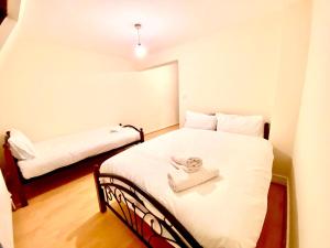 um quarto com uma cama com uma toalha em Spacious Ground Floor Two Bedroom house on in Ealing London em Ealing