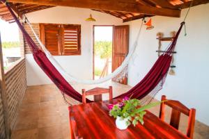 a room with a hammock in a house at Apartamento Floreal in Amontada +29 photos