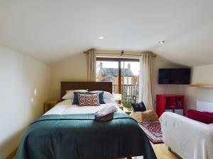 a bedroom with a large bed and a window at Gatelodge Studio, Ballyhackamore in Belfast