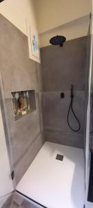 a small bathroom with a shower with a hose at MATTEI LUXURY B&B in Altamura