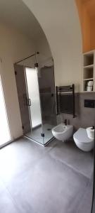 a bathroom with two sinks and a shower and two toilets at MATTEI LUXURY B&B in Altamura