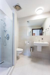 a bathroom with a toilet and a sink and a shower at Penzion U VINAŘSTVÍ ŠABATA in Zaječí