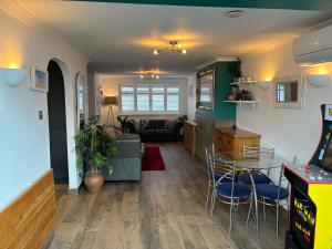 a living room with a table and chairs at House few mins from beach with hot tub & sauna in Shoreham-by-Sea