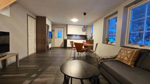 a living room with a couch and a table at Attic floor with views over fields and sea in Sigtuna