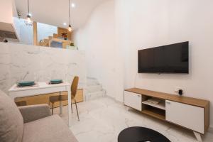 a living room with a television on a wall at Casa Niña in Seville