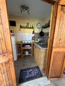 a small kitchen with a sink and a stove at Cottage in Torvaianica