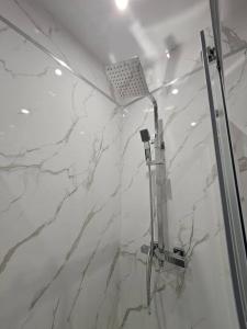a bathroom with a shower with marble walls at Lovely City Home + Free Parking in Manchester