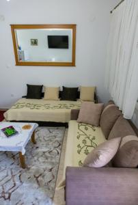 a living room with three beds and a couch at Stavroula's Houses in Kélla