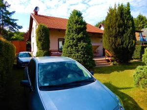 a car parked in front of a house at Holiday Home Kubus in Poddąbie