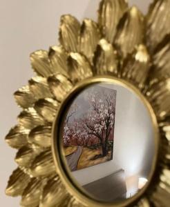 a mirror with a picture of a tree in it at Igea Suite in Noto