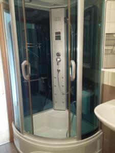 a shower with a glass door in a bathroom at Hostel **Casa del Sole** in Klenovica