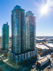 an aerial view of a city with tall buildings at Luxury Corner Unit w Panoramic Tower & Downtown Skyline Views! FREE Banff Pass, Wine, Gym & Parking! in Calgary