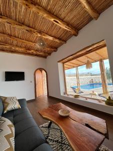 a living room with a couch and a table at Le petit Chalet. in Essaouira