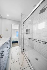 a bathroom with a shower with a glass door at Pure Paradise Kure Beach, Ocean front, Pool coming soon! in Kure Beach