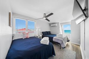 a bedroom with two beds and a view of the ocean at Pure Paradise Kure Beach, Ocean front, Pool coming soon! in Kure Beach