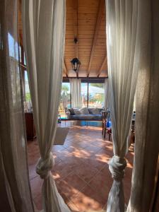 a view of a living room through curtains at Villa Verabetta in San Vito lo Capo
