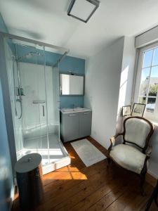 a bathroom with a shower and a chair and a sink at Résidence -pleneuf Val Andre - Maisons & Villas 604 in Pléneuf-Val-André
