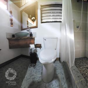 a bathroom with a toilet and a sink at Nirvana Resort in Lívingston