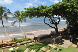 een uitzicht op een strand met stoelen en de oceaan bij Hono Kai Resort C9 in Wailuku