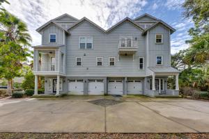 a large white house with two garage doors at St Marys Townhome with Community Hot Tub and Boat Dock in Saint Marys