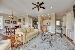 a living room with a couch and a ceiling fan at St Marys Townhome with Community Hot Tub and Boat Dock in Saint Marys
