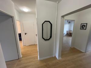 a room with a mirror on the wall and a hallway at Apartament Nati in Cieszyn