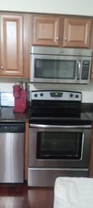 a kitchen with a stove and a microwave at the rest spot in Schenectady