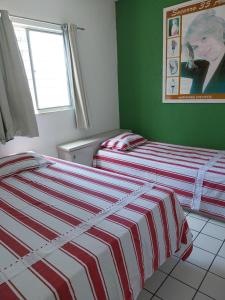 two beds sitting next to each other in a bedroom at Hostel da Socorro in Recife